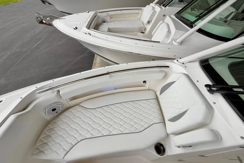 Slide: The Image of 2026 Pursuit DC 266 Dual Console boat with luxurious white seating and sleek design. - 26