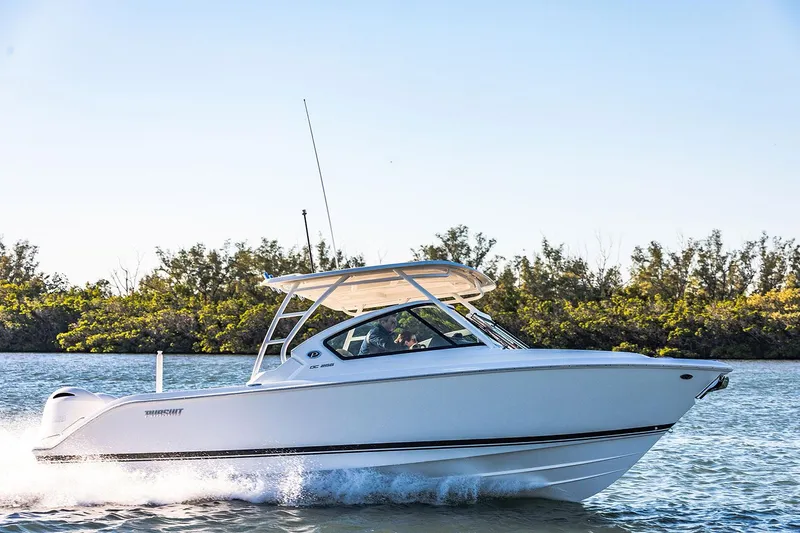 Slide: The Image of Manufacturer Provided Image: 2025 Pursuit DC 266 Dual Console boat cruising on a sunny day. - 3