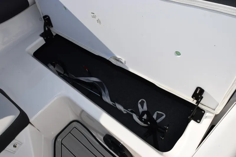 Slide: The Image of 2026 Yamaha Boats 195S storage compartment with open lid and interior view. - 17