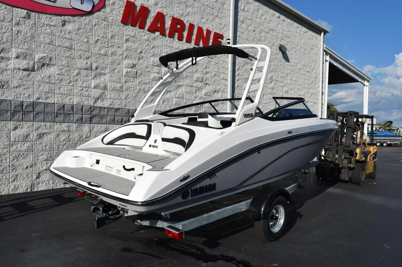 Slide: The Image of 2026 Yamaha Boats 195S on trailer outside marine dealership. - 4
