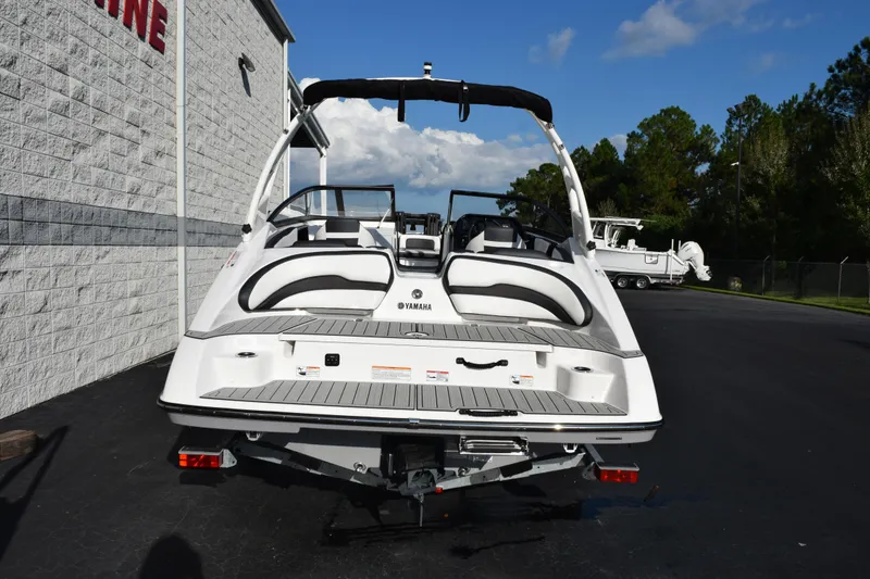 Slide: The Image of 2026 Yamaha Boats 195S, rear view, parked outdoors on a sunny day. - 5