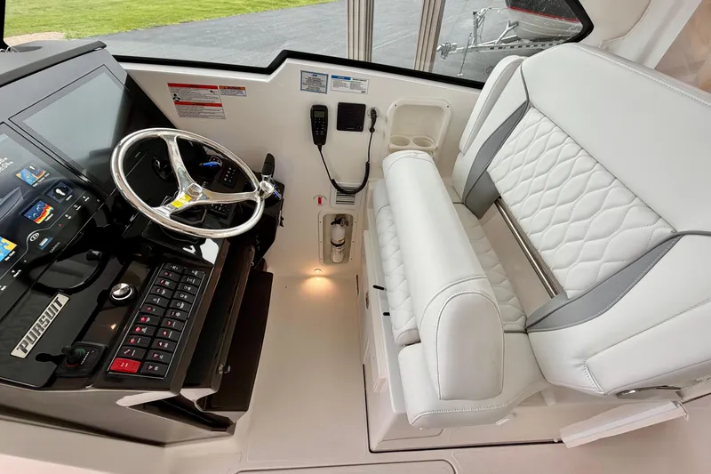 Slide: The Image of Interior of 2026 Pursuit DC 326 Dual Console with steering wheel and seat. - 17