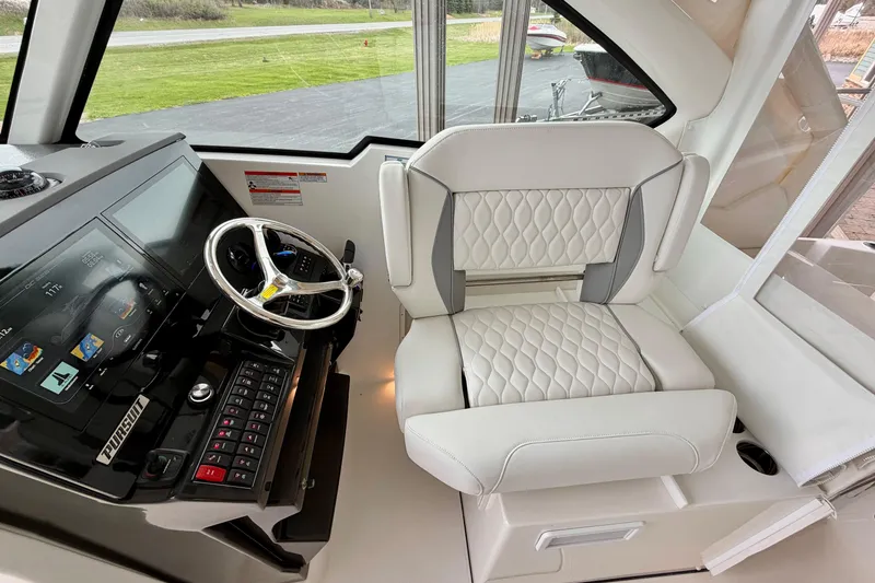 Slide: The Image of Interior of 2026 Pursuit DC 326 Dual Console with helm and seating. - 18