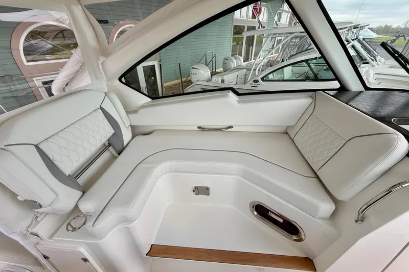 Slide: The Image of Interior of 2026 Pursuit DC 326 Dual Console with luxurious white seating. - 20