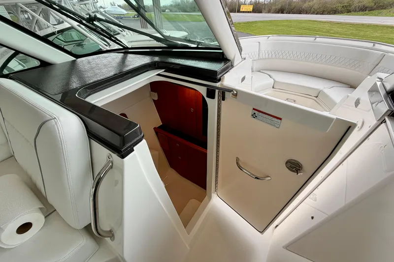 Slide: The Image of Interior of Pursuit DC 326 Dual Console 2026 with open door. - 24