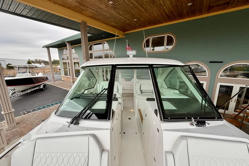 Slide: The Image of 2026 Pursuit DC 326 Dual Console boat docked at marina. - 29