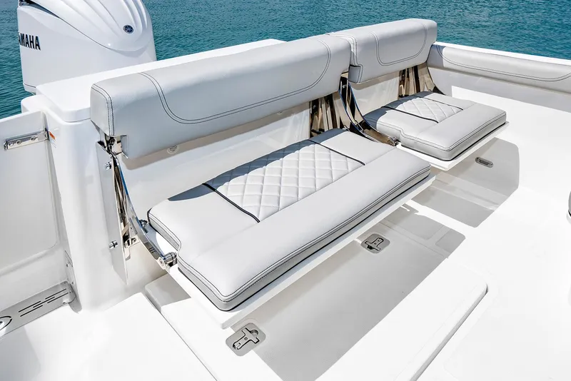 Slide: The Image of Manufacturer Provided Image: 2025 Pursuit DC 246 Dual Console boat with white cushioned seating. - 12