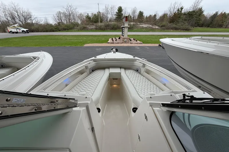 Slide: The Image of 2026 Pursuit DC 246 Dual Console boat interior with cushioned seating and sleek design. - 16