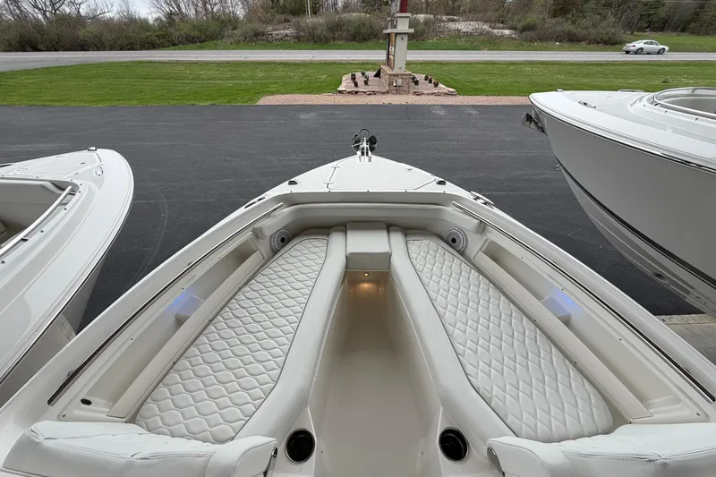 Slide: The Image of 2026 Pursuit DC 246 Dual Console boat with luxurious white seating and sleek design. - 17