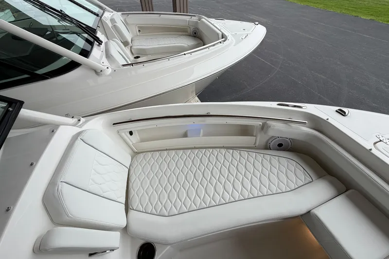 Slide: The Image of 2026 Pursuit DC 246 Dual Console boat with luxurious white seating and sleek design. - 18