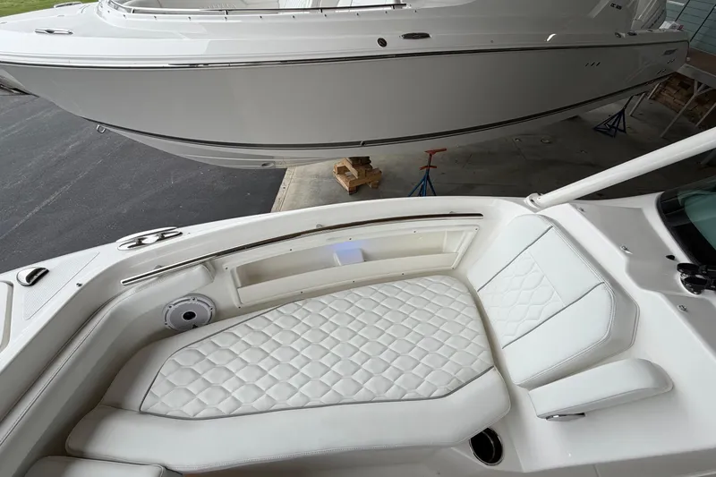 Slide: The Image of 2026 Pursuit DC 246 Dual Console boat with luxurious white seating and sleek design. - 19