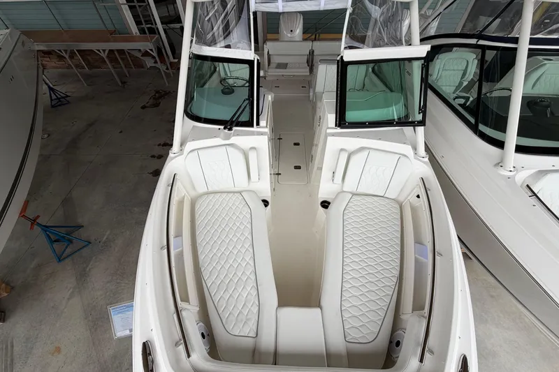 Slide: The Image of 2026 Pursuit DC 246 Dual Console boat with luxurious seating and sleek design. - 21