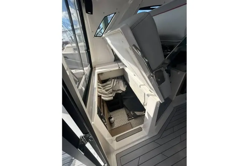 Slide: The Image of 2026 Solara S-310 SB boat interior with seating and storage area, featuring modern design elements. - 15