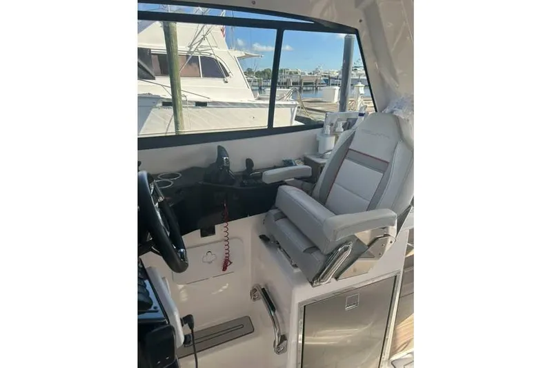 Slide: The Image of Interior of 2026 Solara S-310 SB boat with captain's chair and control panel. - 6