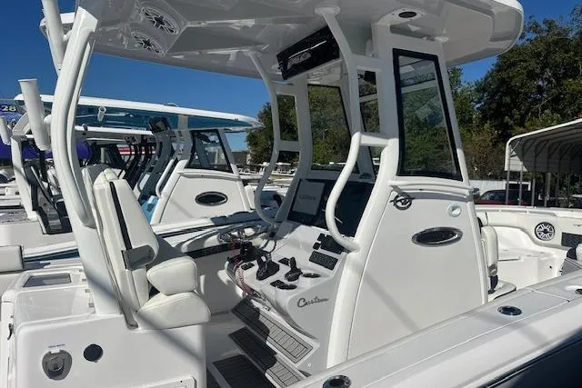 Slide: The Image of 2026 Tidewater 282 CC Adventure boat interior with modern helm and seating. - 11