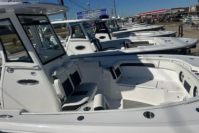 Slide: The Image of 2026 Tidewater 282 CC Adventure boats lined up at a dealership. - 5