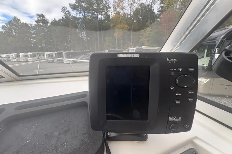 Slide: The Image of Humminbird GPS device on 2012 Clearwater 2100 WA boat dashboard, surrounded by parked RVs. - 13