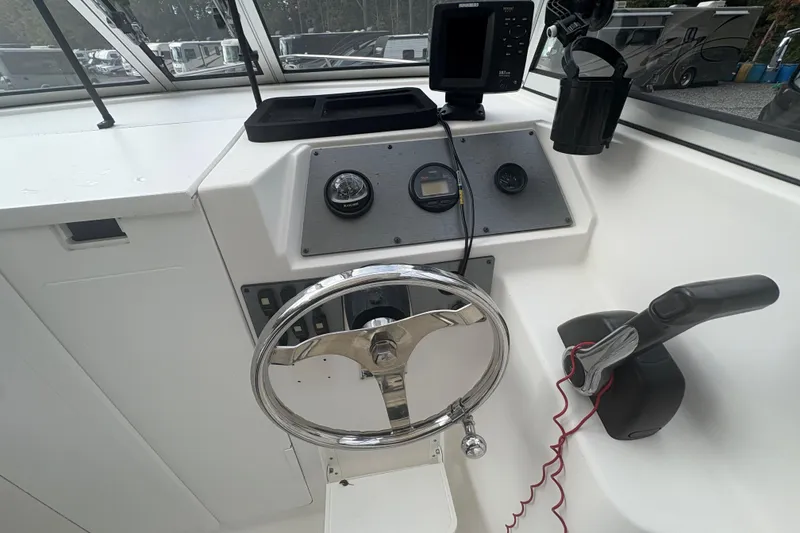 Slide: The Image of Steering console of 2012 Clearwater 2100 WA boat with gauges and controls. - 6