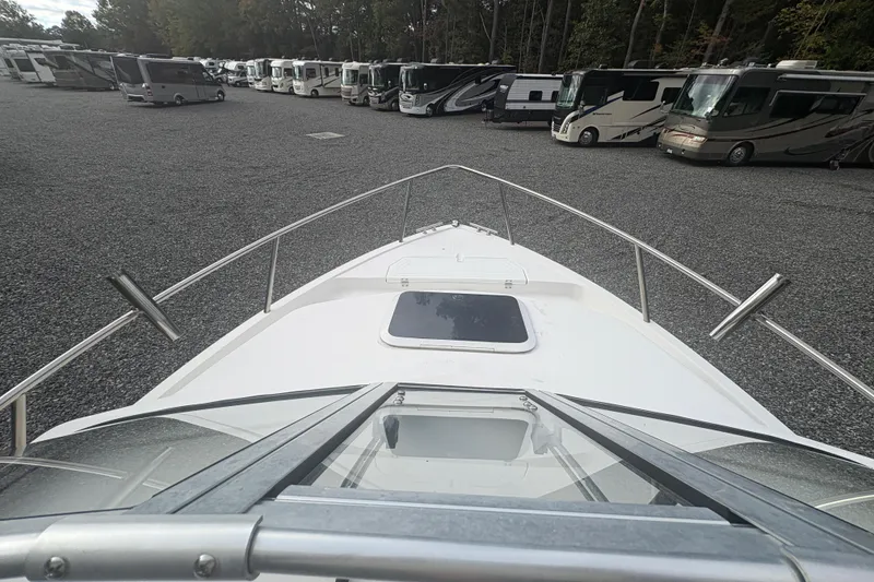 Slide: The Image of 2012 Clearwater 2100 WA boat in storage lot with RVs in background. - 12