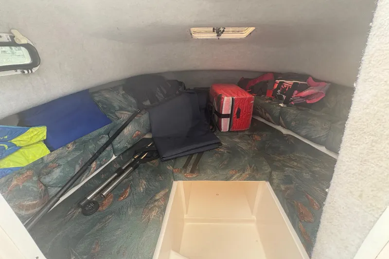 Slide: The Image of 2012 Clearwater 2100 WA cabin interior with seating and storage items. - 15