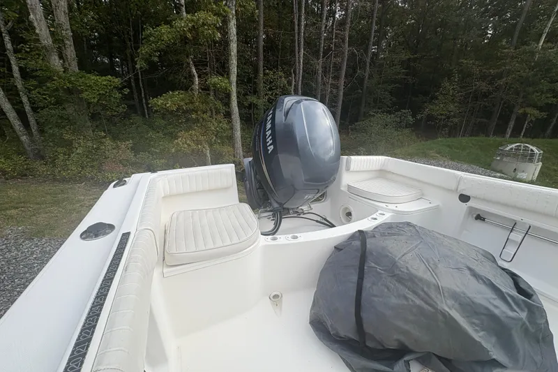 Slide: The Image of 2012 Clearwater 2100 WA boat with Yamaha engine, parked near forested area. - 8