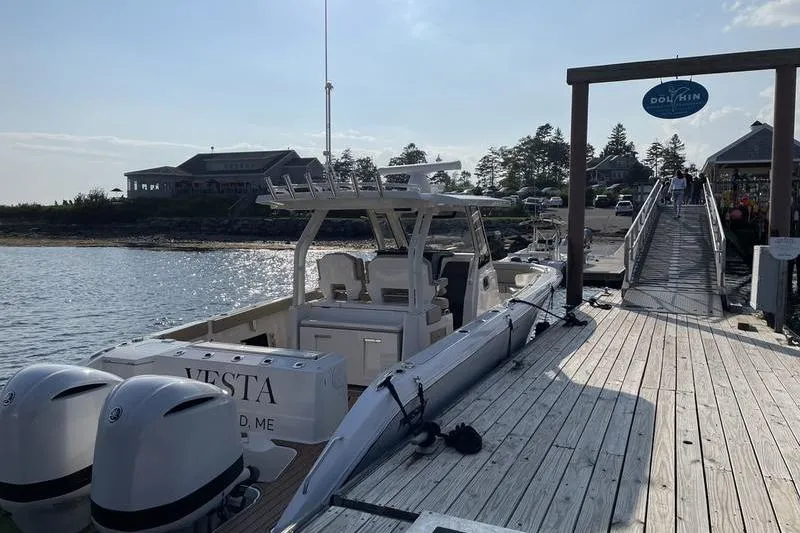 Slide: The Image of 2019 Pursuit S 328 Sport boat docked at a scenic marina. - 7