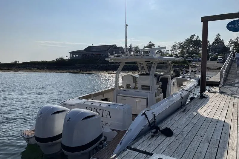 Slide: The Image of 2019 Pursuit S 328 Sport boat docked by a scenic waterfront. - 9