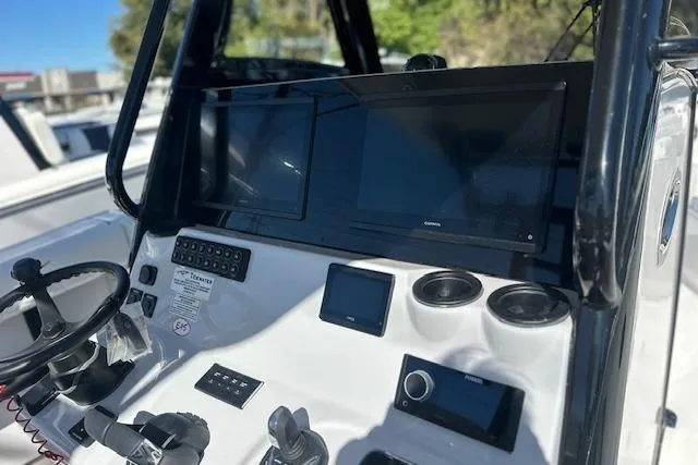 Slide: The Image of 2026 Tidewater 302 CC Adventure boat dashboard with modern navigation equipment. - 10