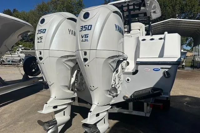 Slide: The Image of 2026 Tidewater 302 CC Adventure with twin Yamaha 350 V6 engines, docked outdoors. - 2