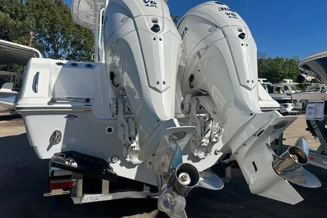 Slide: The Image of Twin outboard engines on a 2026 Tidewater 302 CC Adventure boat, parked outdoors. - 3