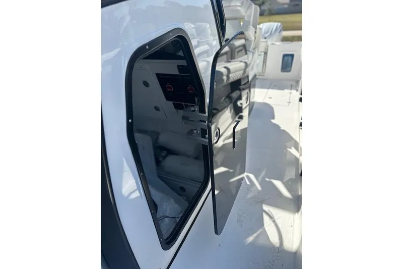 Slide: The Image of 2026 Tidewater 302 CC Adventure boat interior view with open hatch. - 4