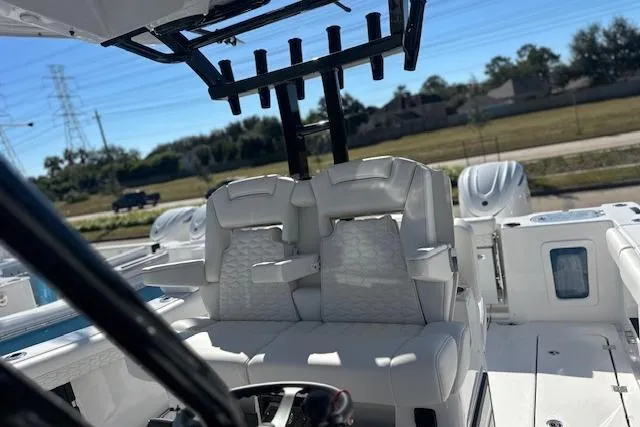 Slide: The Image of 2026 Tidewater 302 CC Adventure boat interior with dual seats and steering wheel. - 5