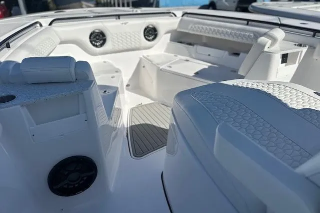 Slide: The Image of 2026 Tidewater 302 CC Adventure boat interior with white seating and speakers. - 6