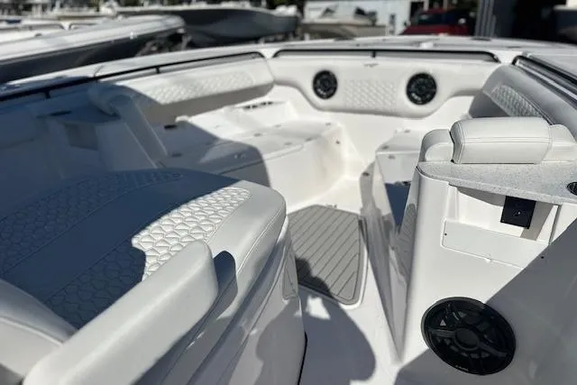 Slide: The Image of 2026 Tidewater 302 CC Adventure boat interior with white seating and speakers. - 7