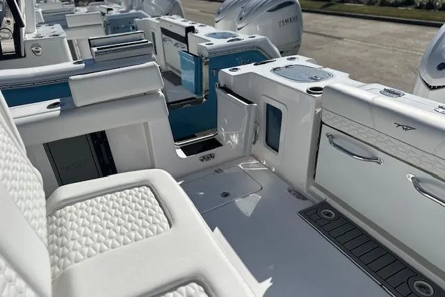 Slide: The Image of 2026 Tidewater 302 CC Adventure boat interior with white seating and modern amenities. - 8