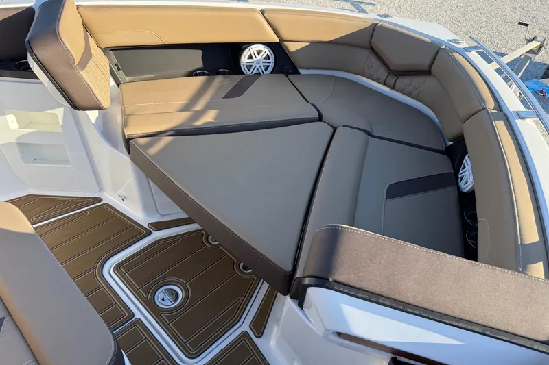 Slide: The Image of Luxurious seating on 2026 Monterey Elite 30 OB boat, featuring brown upholstery and sleek design. - 10