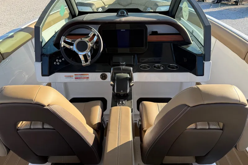 Slide: The Image of Interior view of 2026 Monterey Elite 30 OB boat cockpit with modern steering and seating. - 12