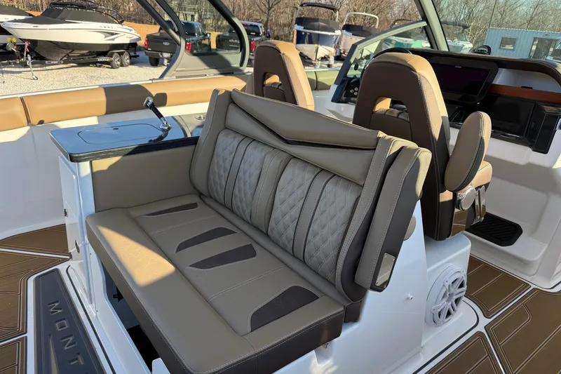 Slide: The Image of Interior of 2026 Monterey Elite 30 OB boat with luxurious seating and modern dashboard. - 13