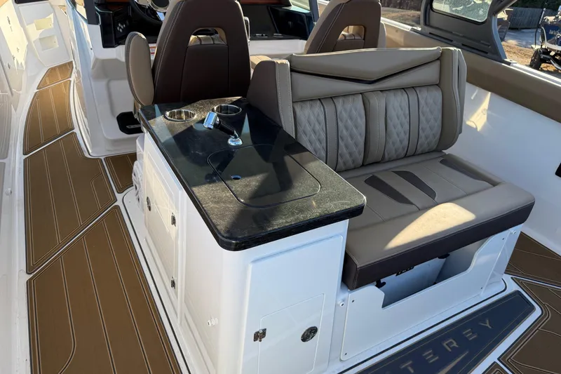 Slide: The Image of 2026 Monterey Elite 30 OB boat interior with luxurious seating and sleek design. - 15