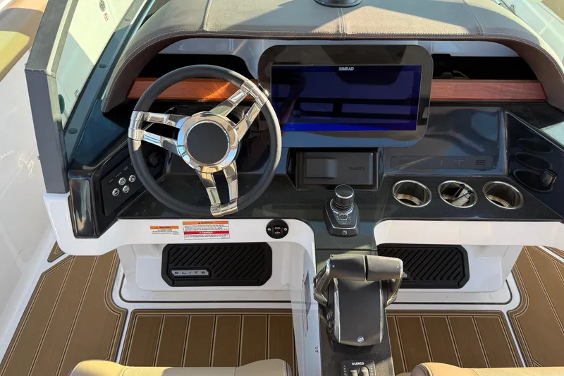 Slide: The Image of Cockpit of 2026 Monterey Elite 30 OB boat with modern steering and controls. - 16