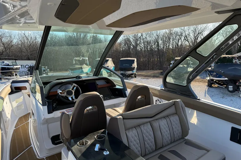 Slide: The Image of Interior view of 2026 Monterey Elite 30 OB boat with modern helm and seating. - 17