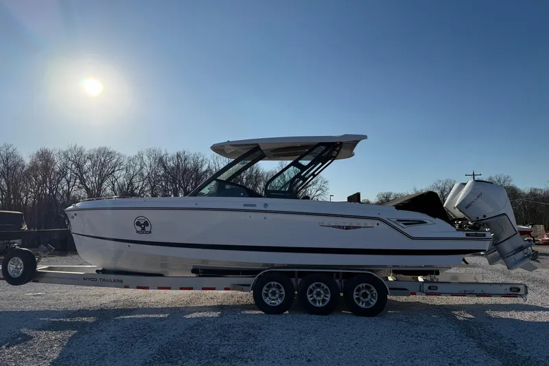 Slide: The Image of 2026 Monterey Elite 30 OB boat on trailer under clear sky. - 6