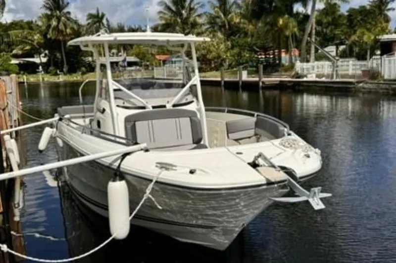 The Image of 2023 Jeanneau Leader 7.5 CC S3 boat docked in a serene canal setting. - 1