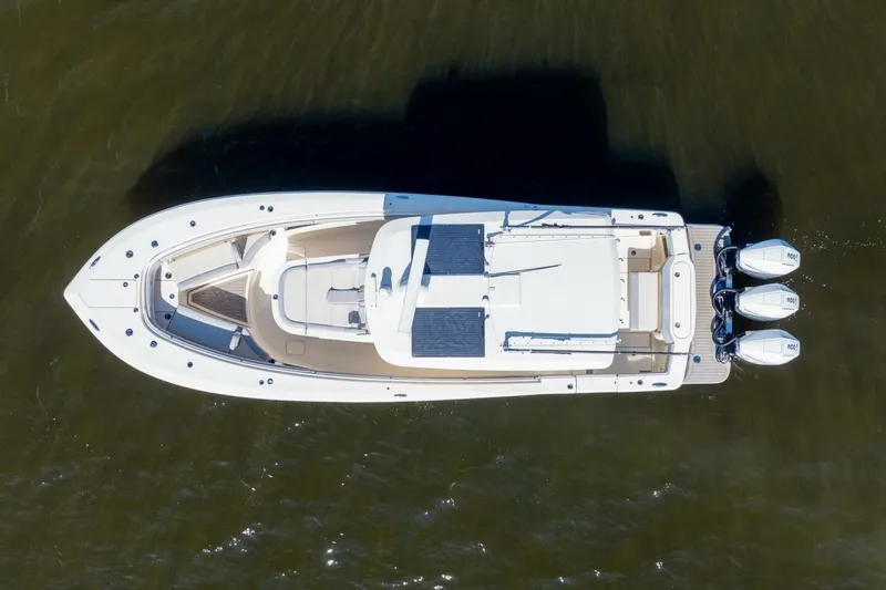 Slide: The Image of Aerial view of 2023 Scout 355 LXF boat with triple outboard engines. - 3