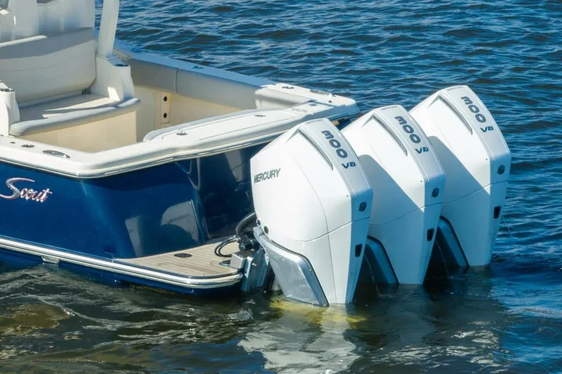 Slide: The Image of 2023 Scout 355 LXF boat with triple Mercury 300 V8 engines on water. - 5