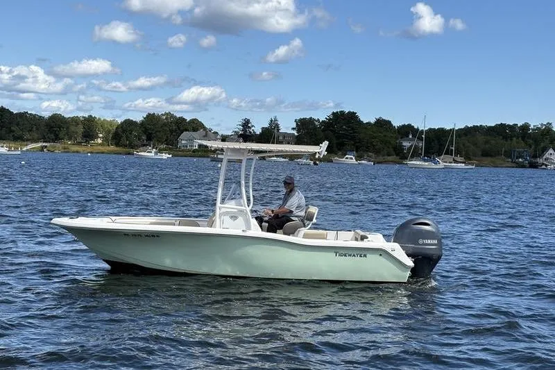 The Image of 2019 Tidewater 210 CC Adventure boat on water with Yamaha engine, scenic background. - 1