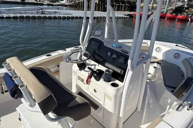 Slide: The Image of 2019 Tidewater 210 CC Adventure boat cockpit with steering wheel and control panel. - 5