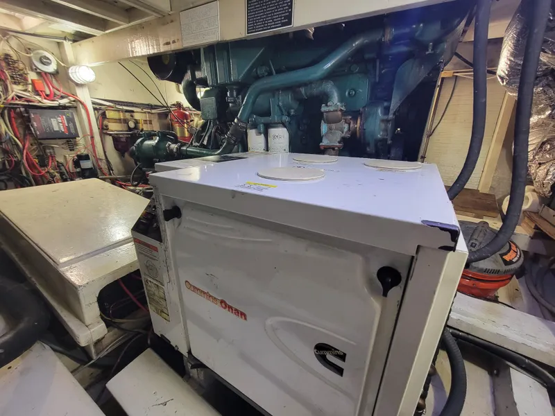 Slide: The Image of Engine room of 1998 Custom Carolina 45 Willis Boatworks, featuring Cummins Onan generator. - 35