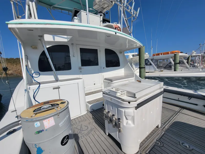 Slide: The Image of Custom Carolina 45 Willis Boatworks 1998, docked with fishing equipment on deck, clear sky background. - 10