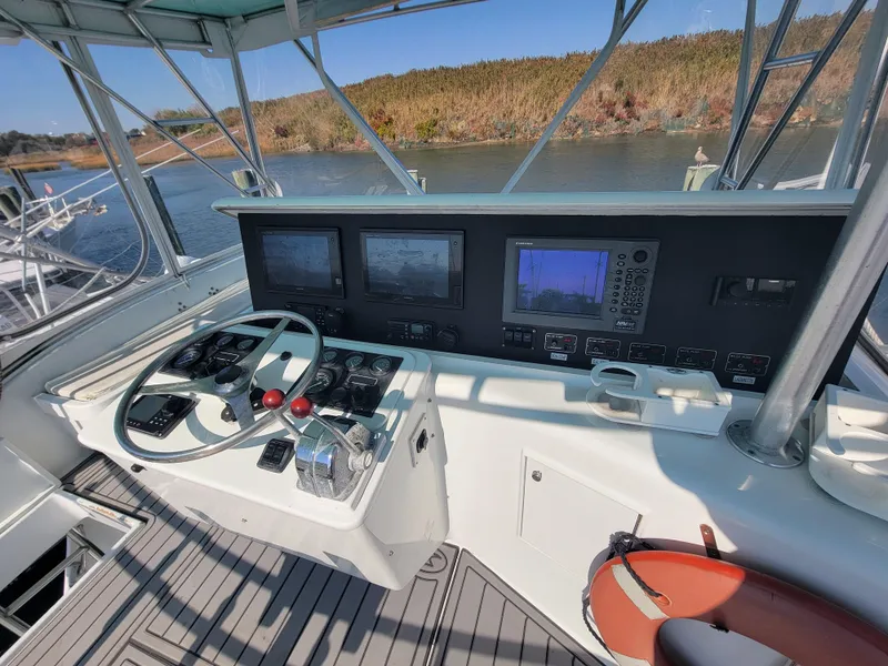 Slide: The Image of Helm of 1998 Custom Carolina 45 Willis Boatworks with navigation equipment and steering wheel. - 12